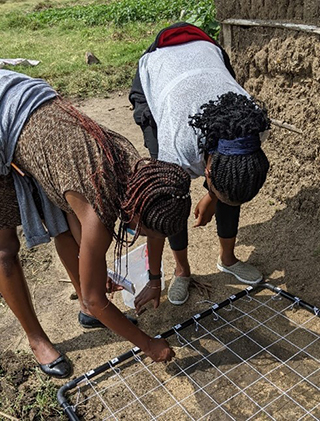 two people looking at the ground