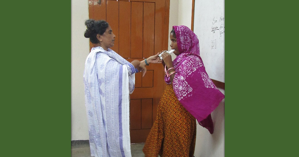 a person administering a breathing test to another person