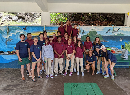 group of team members in front of a mural