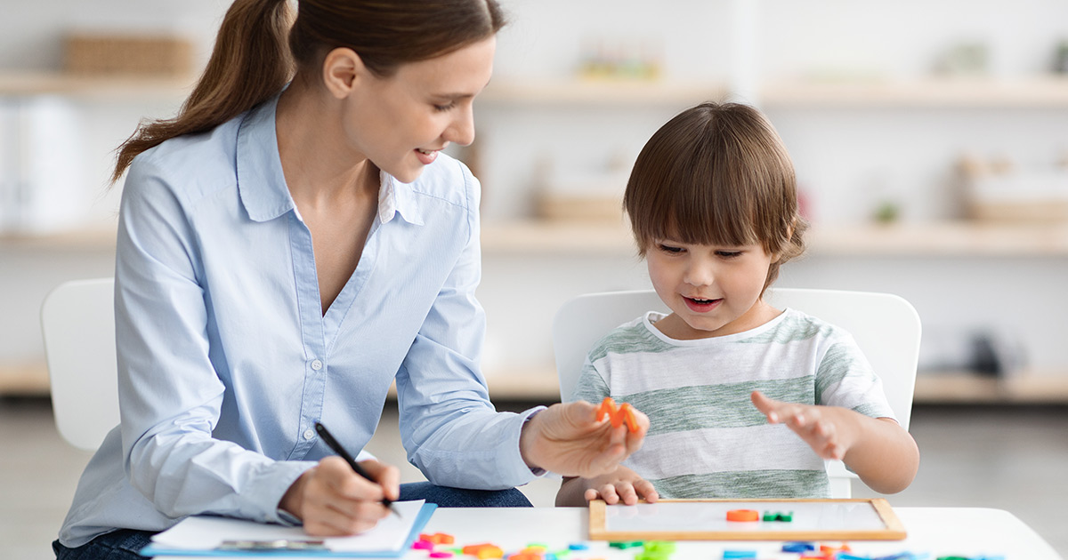 woman testing a child in a classroom