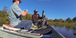 Upal Ghosh and a colleague in a boat on the river with sampling equipment