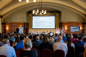 Room of people watching a presentation
