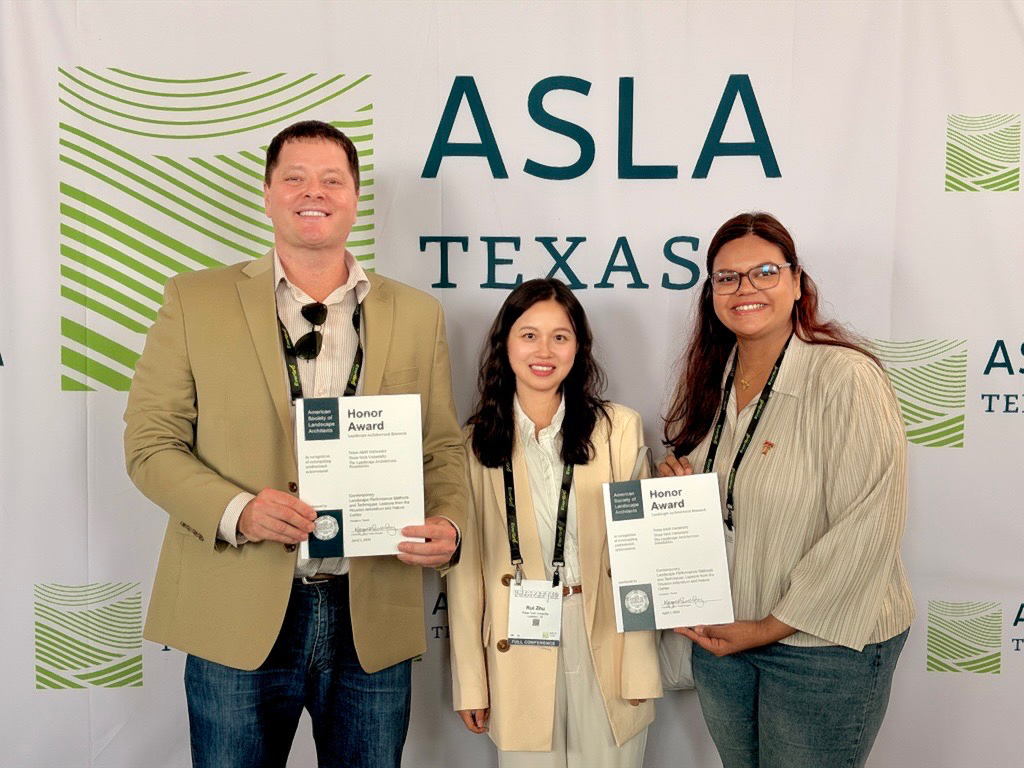 People in suits standing in front of ASLA sign