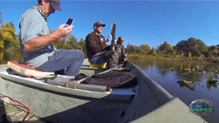 colleagues collect sediment samples by boat to measure PCBs