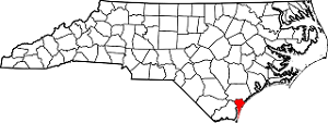 A black and white graphic of North Carolina counties with the county where Wilmington is located highlighted in red