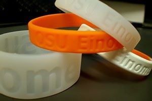 Various orange and white silicone wristbands