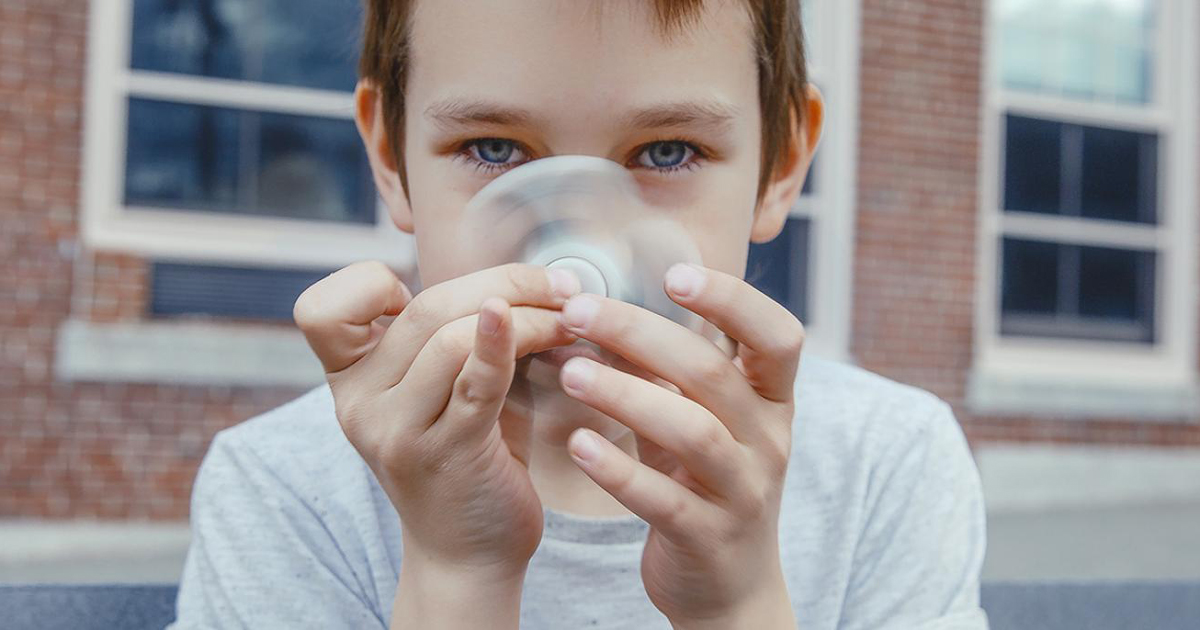 child with a fidget spinner