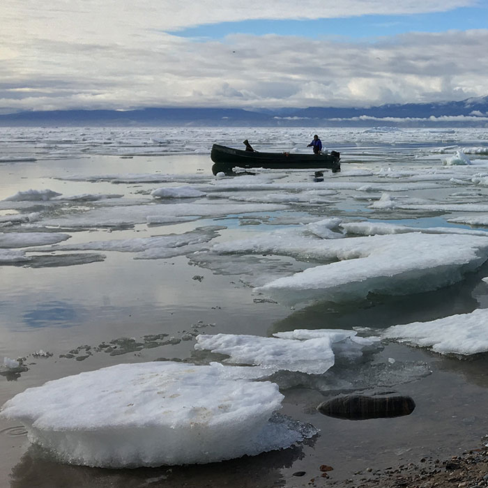 Inuit harvesters boating along the shore of Mittimatalik (Pond Inlet) in the Canadian territory of Nunavut.