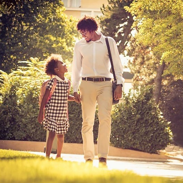 man and little girl holding hands and looking at each other