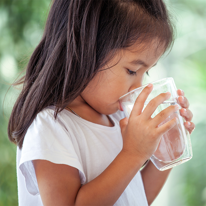 Little girl drinking water.