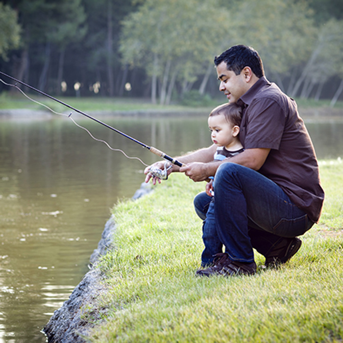 Father and young son going fishing at a lake