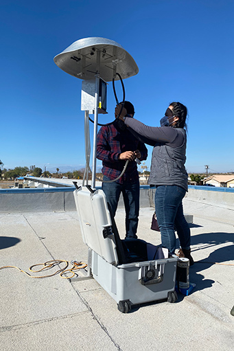 Yoshira Van Horne, Ph.D., and Edgar Ruiz on rooftop