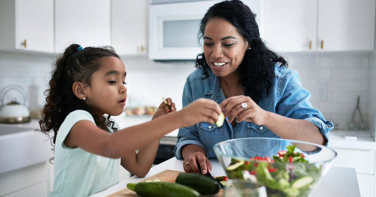 parent and child prepping vegetables