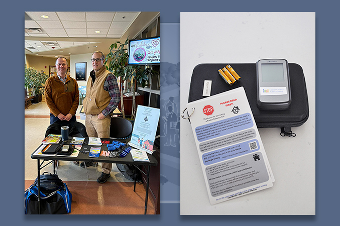 men standing at a table with Radon Action Month materials and a radon test kit