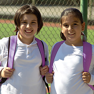 two girls wearing backpacks
