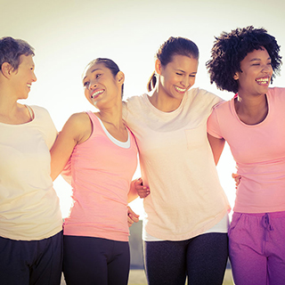 group of woman hugging and smiling