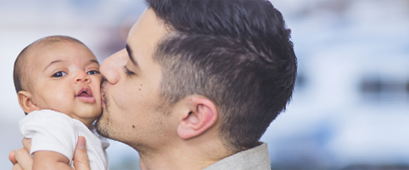Man kissing a baby on the cheek