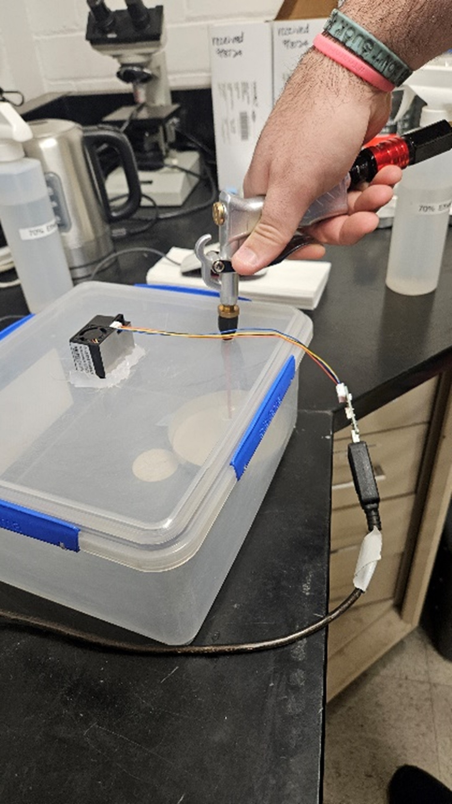 A scientist testing the wind tunnel apparatus