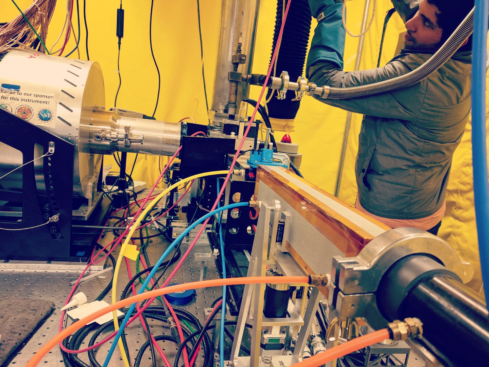 Lab setup of fiber cables with Nabil Shaikh standing in background