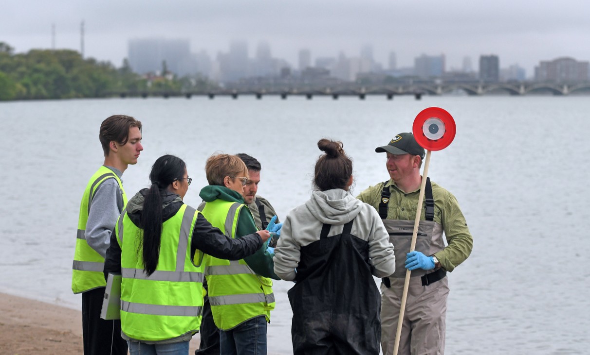 A group of students standing by the water