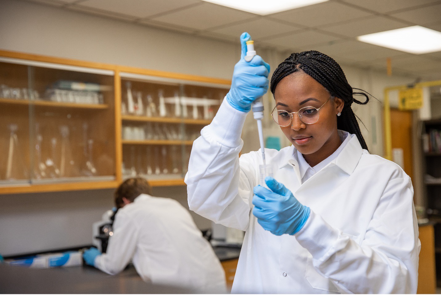 Ariel pipetting a sample in the lab