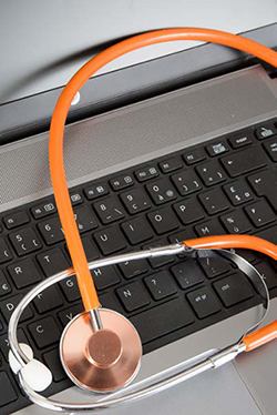 stethoscope on laptop keyboard
