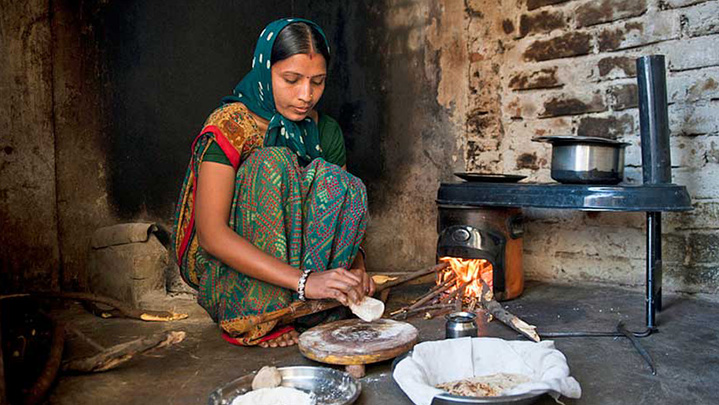 woman cooking by a fire