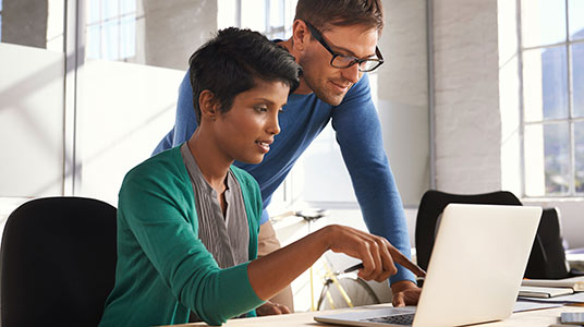 man and woman observing a laptop screen