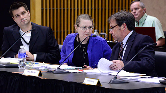 a group of people at a conference room table
