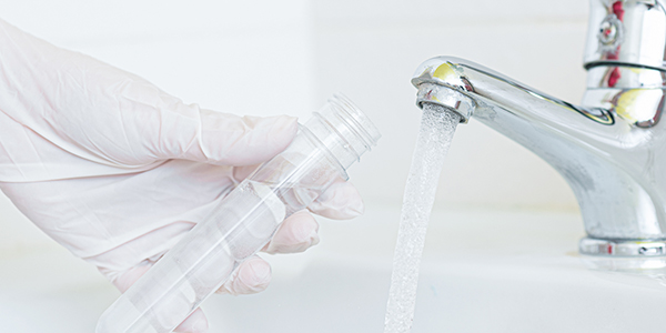 filling a test tube with water from a faucet