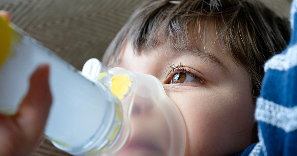 kid with inhaler held to his face