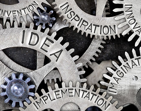 gear cogs with the words idea, inspiration, and implementation stamped on them