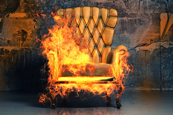 wingback chair covered in flames 
