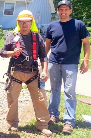 Image of two men standing before a home construction site