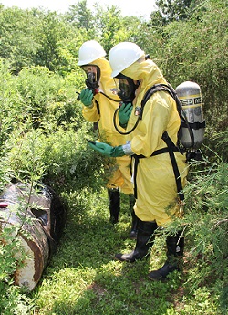 WTP Trainees assessing disposed waste with monitoring devices and safety gear