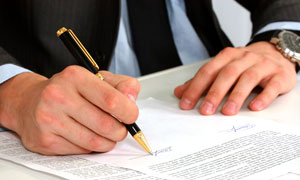 Man signing financial document