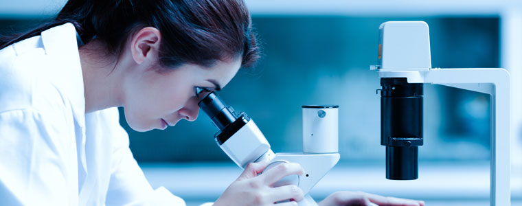 Woman looking through microscope