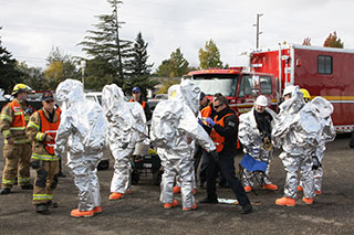 team of firefighters and hazmat cleanup crew