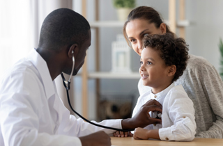 Doctor listening to child's heartbeat