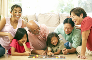 Family sitting together playing a board game