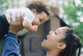 Lady holding up a baby