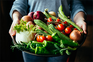 variety of vegetables being held in a plate