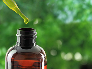 bottle of essential oil with oil dripper