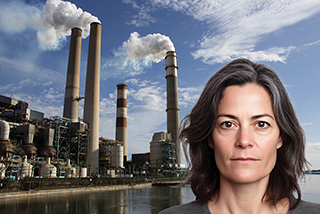 Industrial plant producing pollution with woman in background