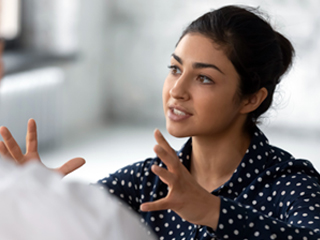 woman using her hands as she is speaking