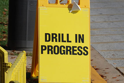 drill in progress street sign