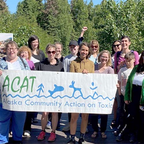 crowd holding an Alaska Arctic Communities on Toxics banner