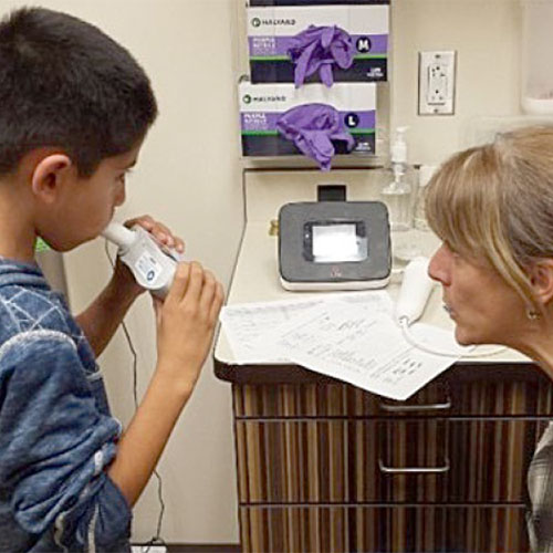 child taking a breathing test
