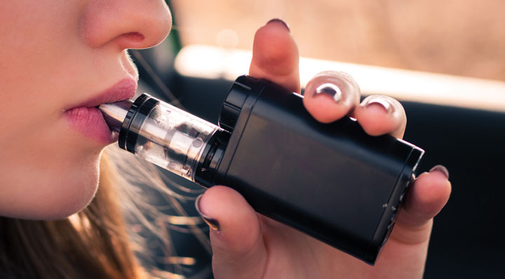 woman using vape pen