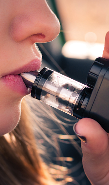 Woman using vaping pen